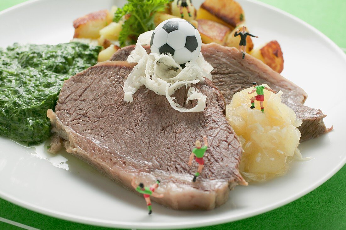 Boiled beef with accompaniments and football figures