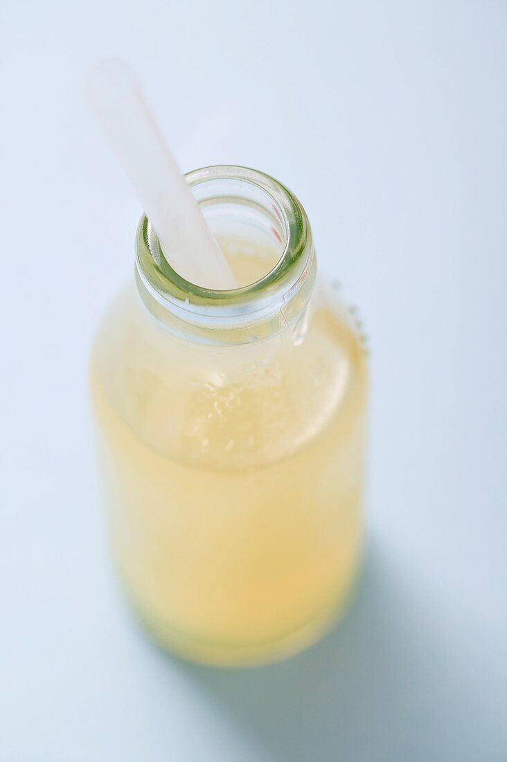 Lemon juice in bottle with straw