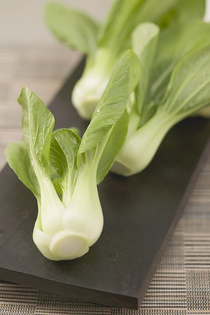 Fresh pak choi on chopping board