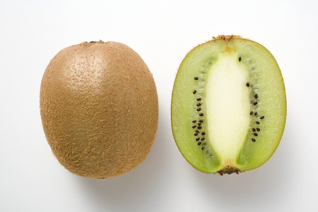Whole kiwi fruit & half a kiwi fruit (longitudinal section)