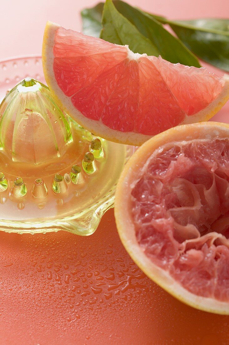 Pink grapefruit wedge, squeezed grapefruit, citrus squeezer