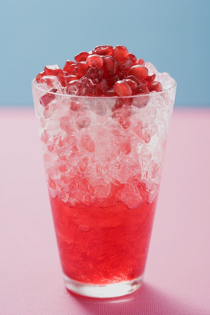 Glass of pomegranate juice with crushed ice & pomegranate seeds