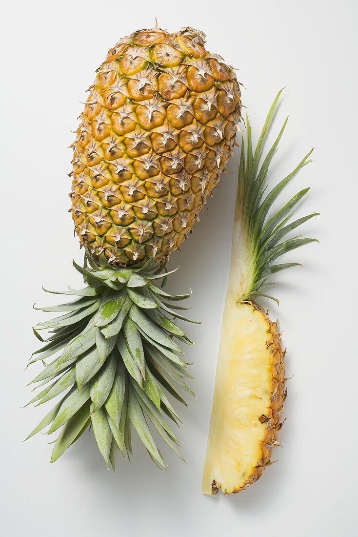 Whole pineapple with wedge of pineapple