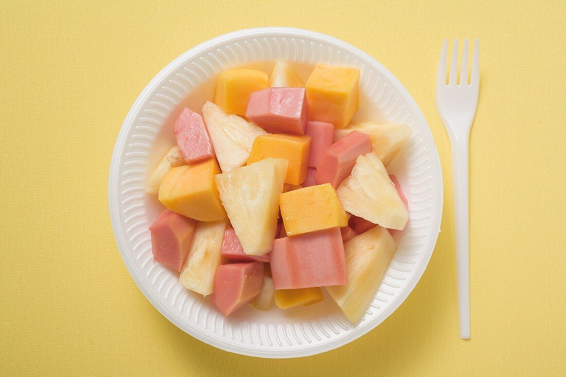 Exotic fruit salad in plastic dish (overhead view)