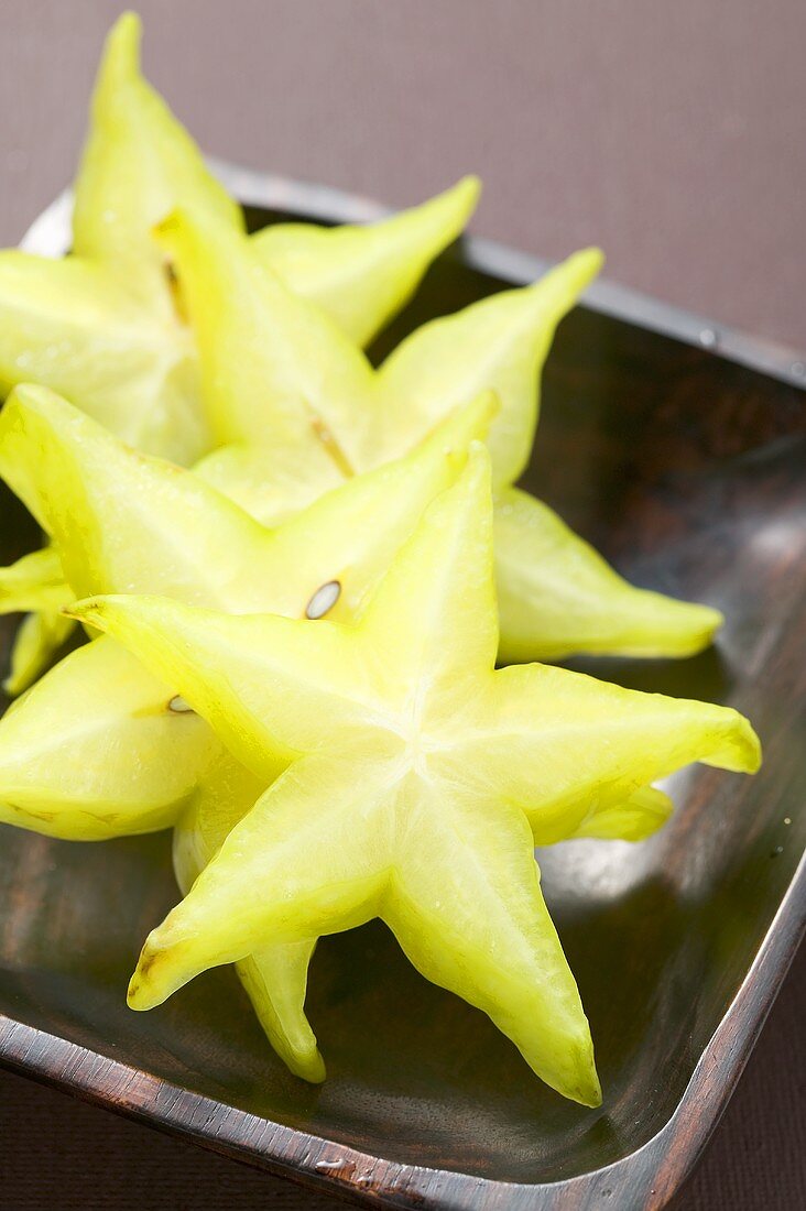 Carambola slices in wooden dish