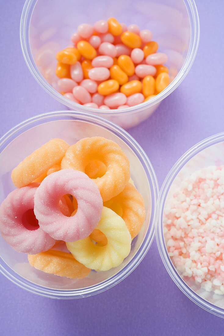 Sugar rings and other sweets in plastic tubs