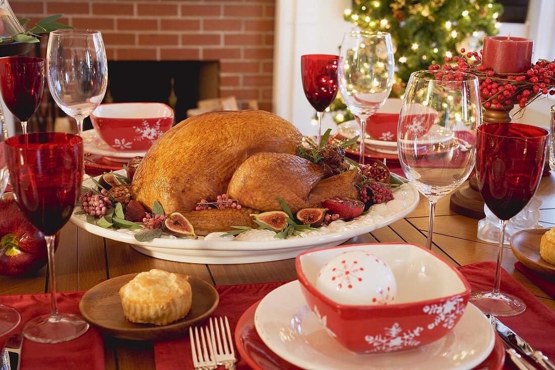 Roast turkey on Christmas table in front of fireplace