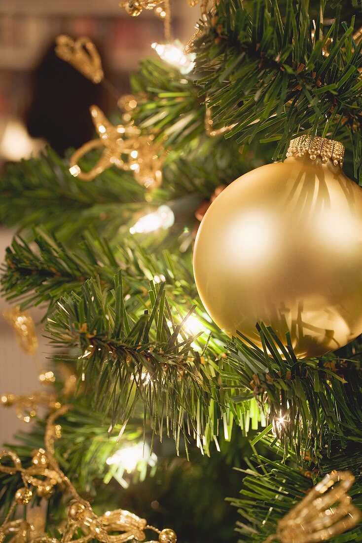 Gold Christmas tree ornament and fairy lights