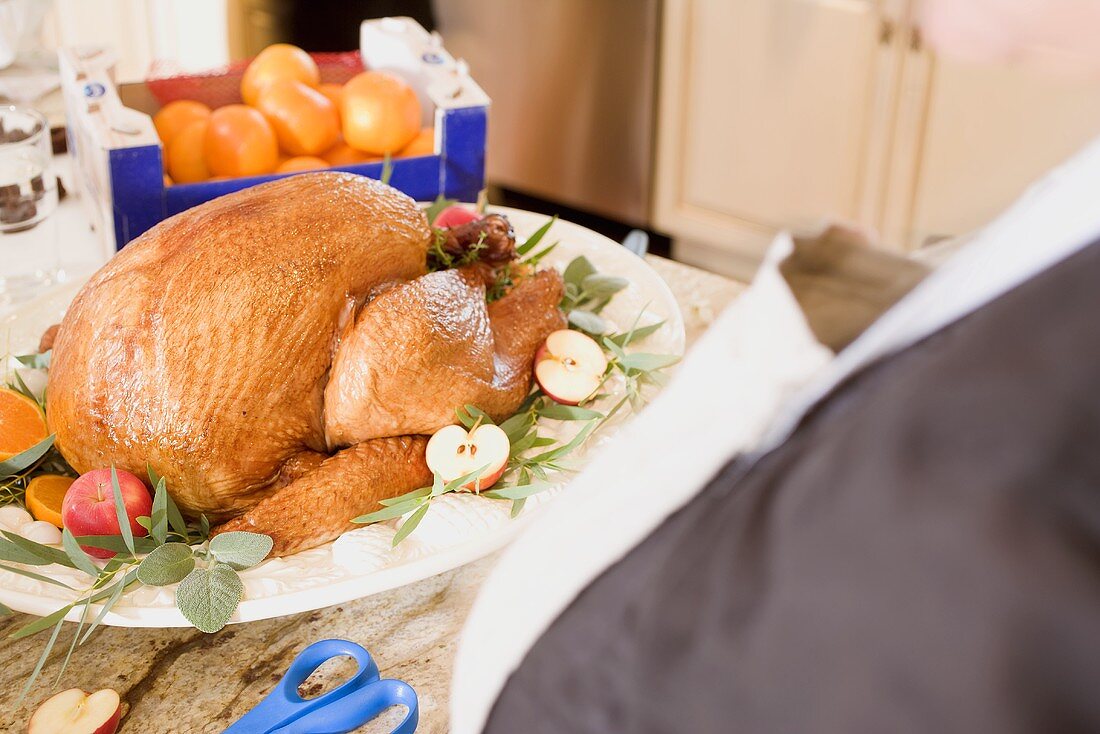 Garnishing roast turkey on a platter