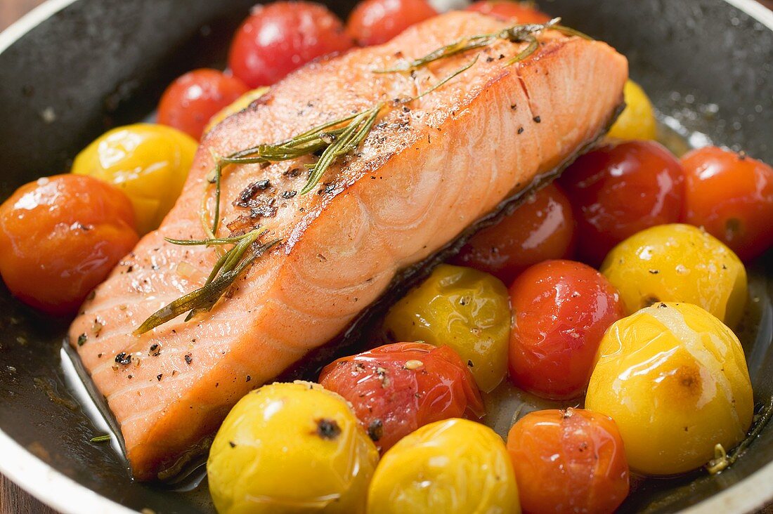 Gebratenes Lachsfilet mit Kirschtomaten in Pfanne