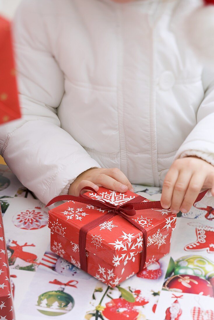 Child opening Christmas parcel