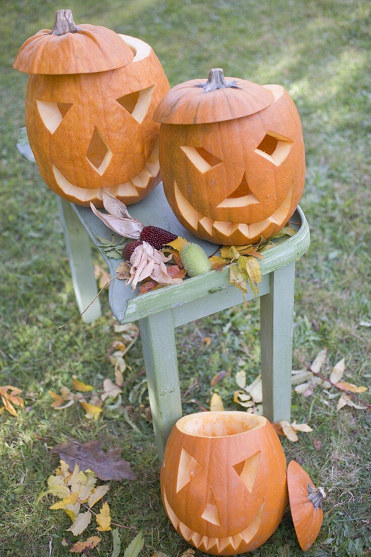 Carved pumpkin faces on garden table