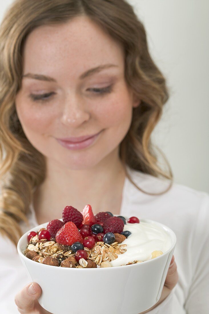 Woman holding berry muesli