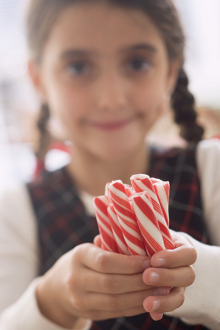 Girl holding several candy sticks