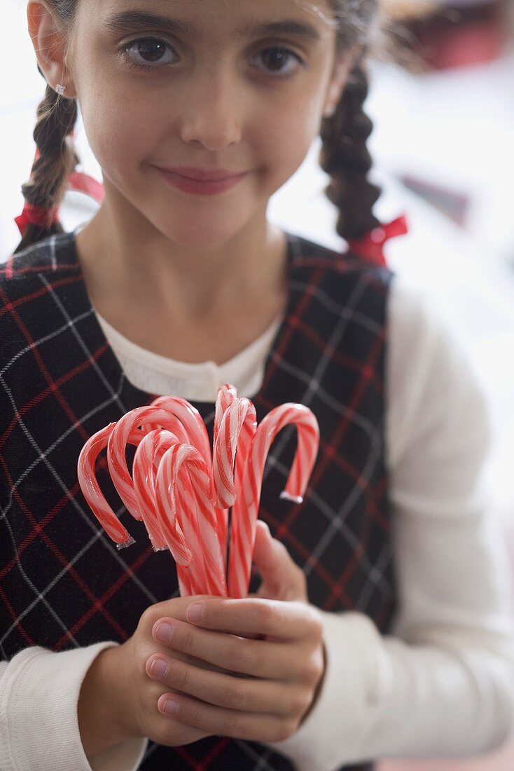 Girl holding candy canes