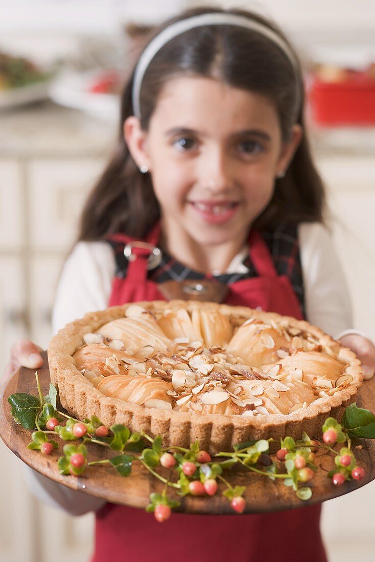 Girl holding freshly-baked apple tart