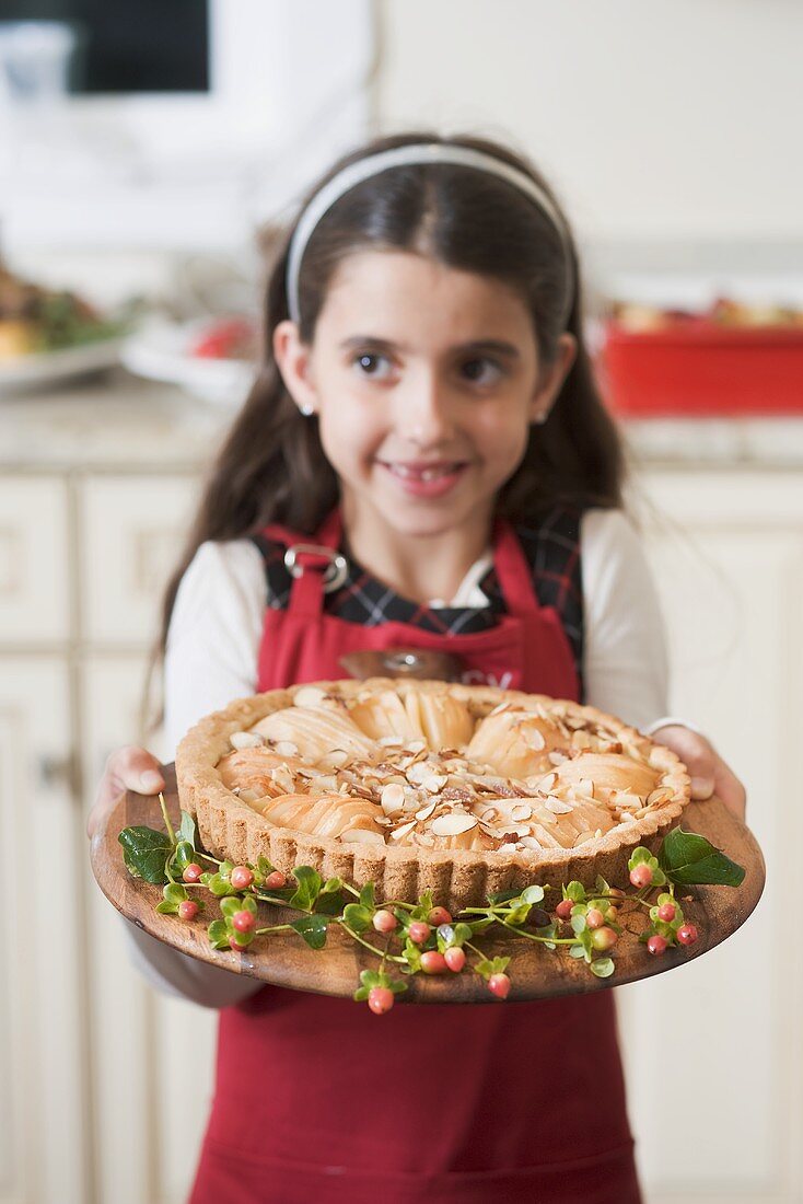 Girl holding freshly-baked apple tart