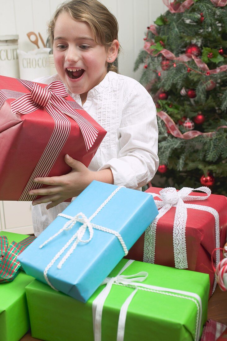 Girl with lots of Christmas gifts