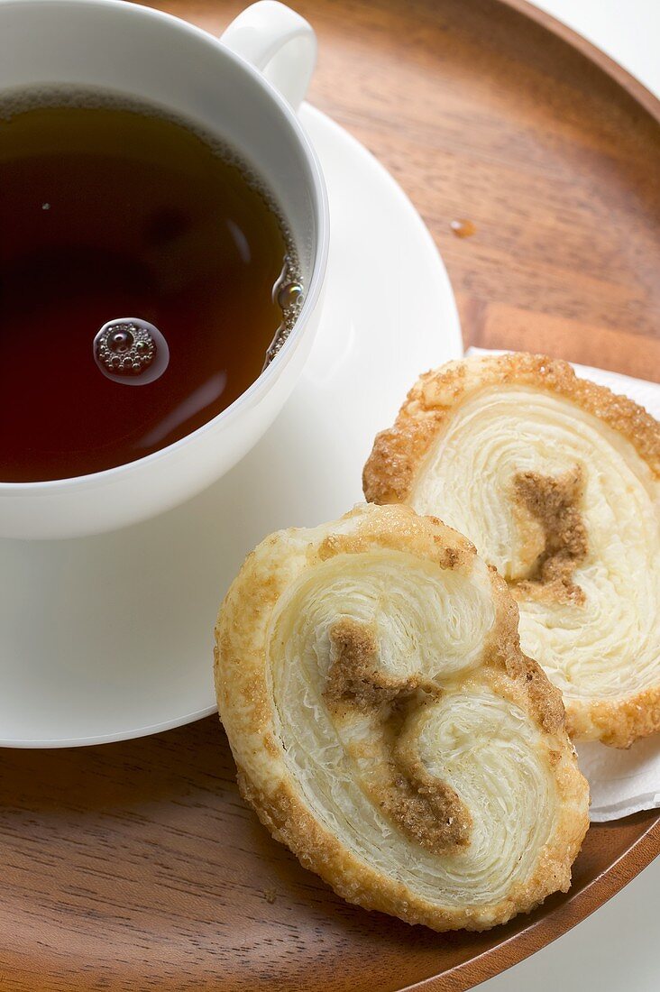 Palmiers (puff pastry biscuits) and cup of coffee