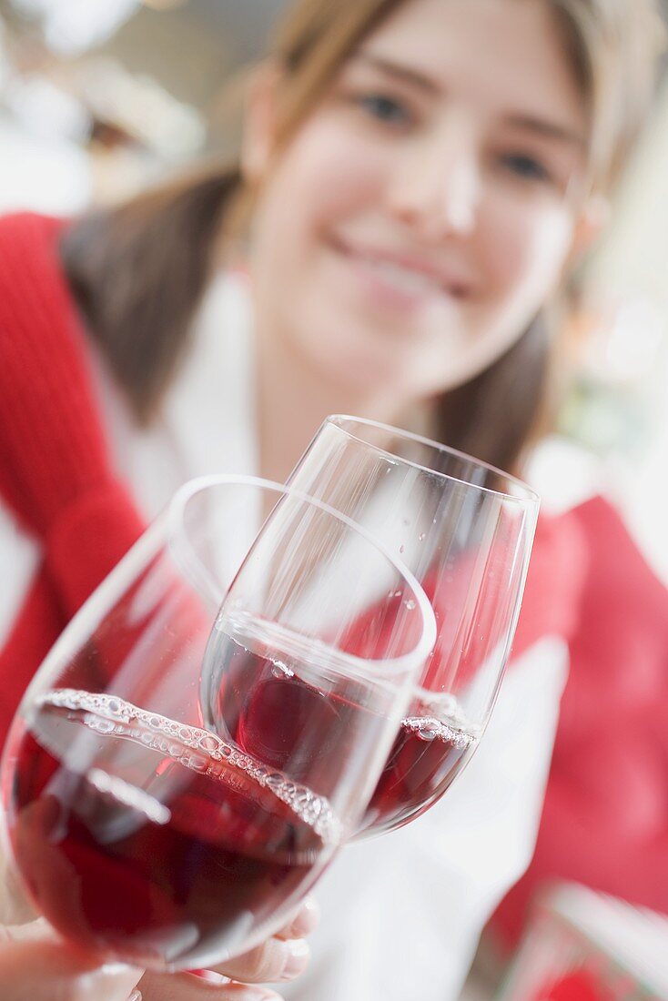 Young woman raising glass of wine (Christmas)