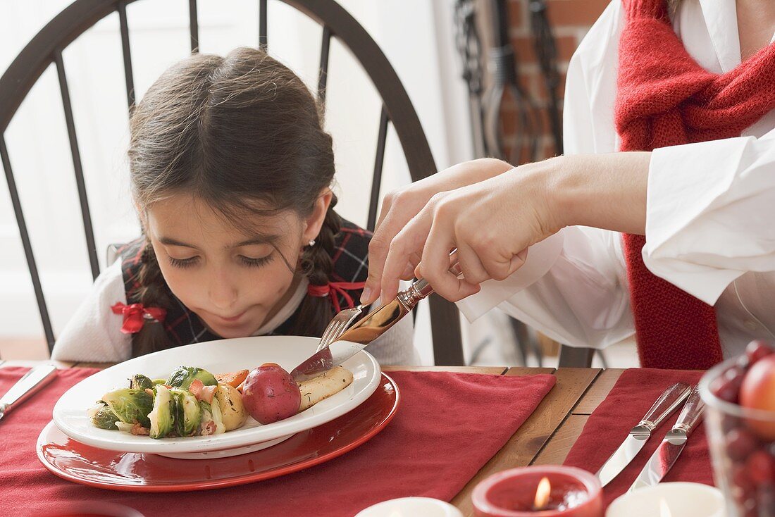 Woman and child eating Christmas dinner (USA)