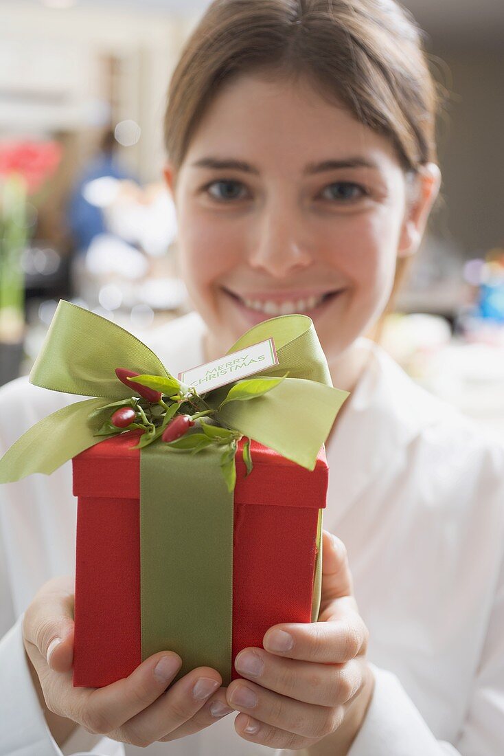 Young woman holding Christmas gift