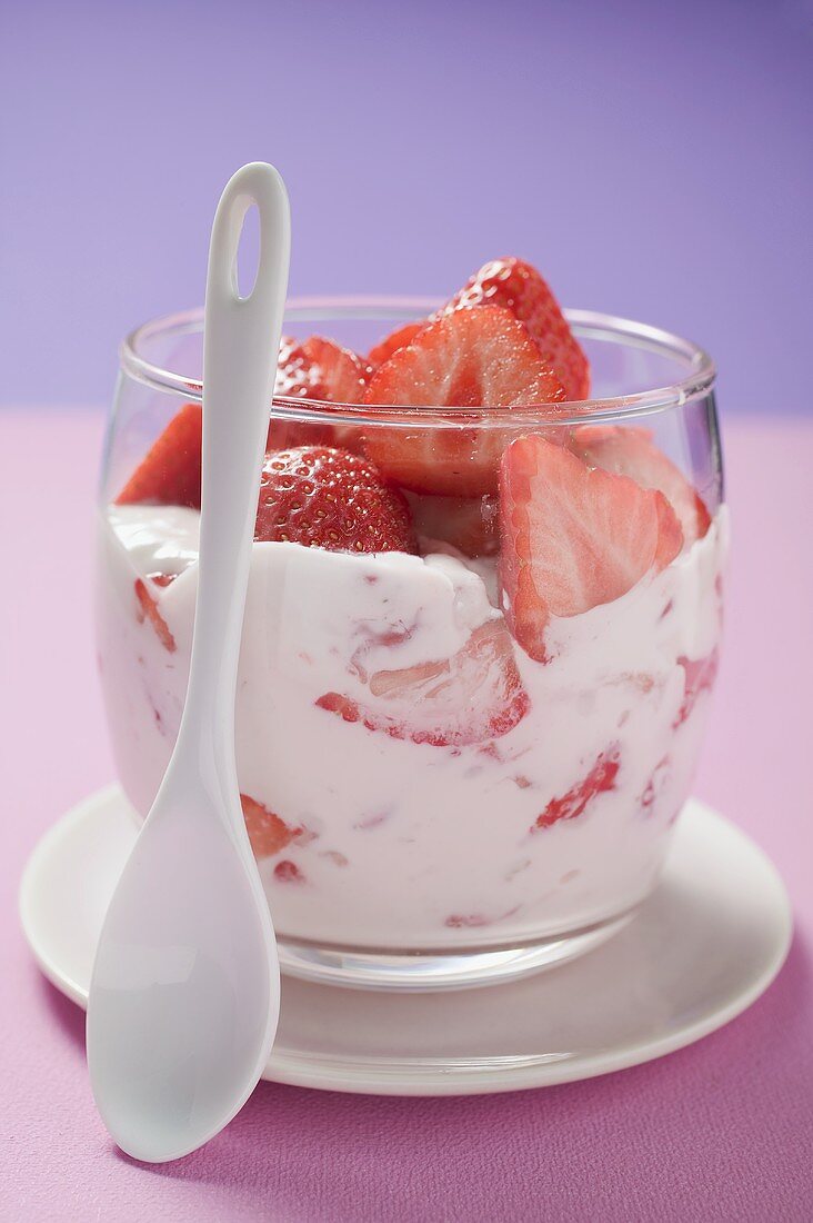 Strawberry quark in glass, spoon in front
