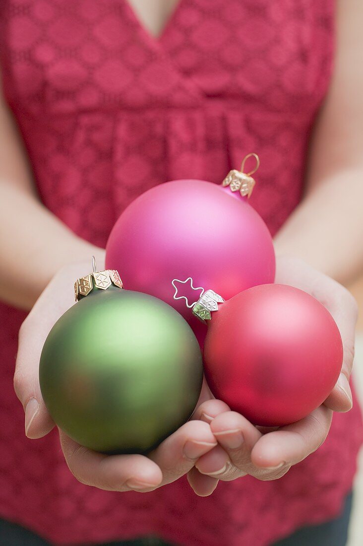 Woman holding Christmas baubles