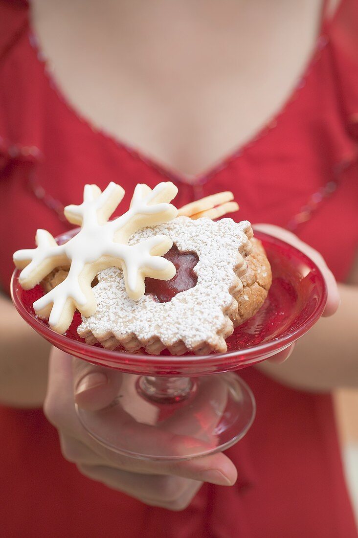 Woman holding dish of Christmas biscuits