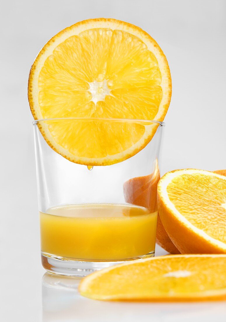 Glass of orange juice and orange slices