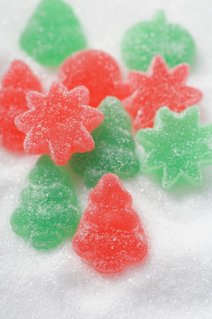 Christmassy jelly sweets on white sugar