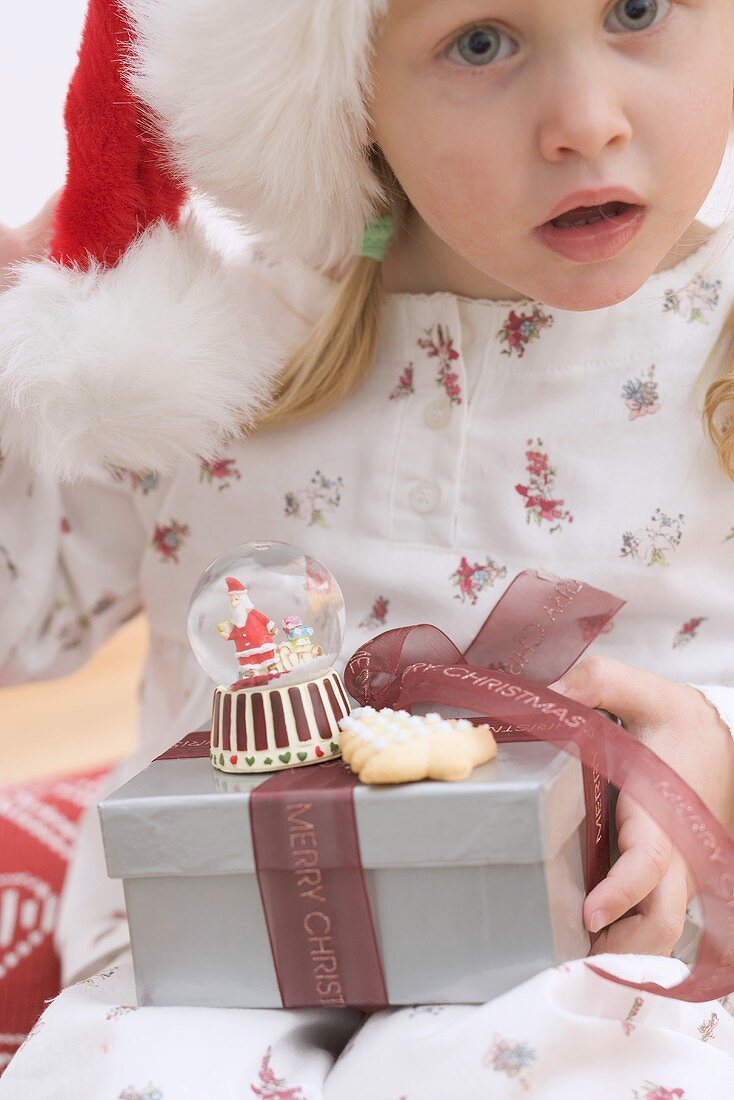 Small girl holding Christmas gifts