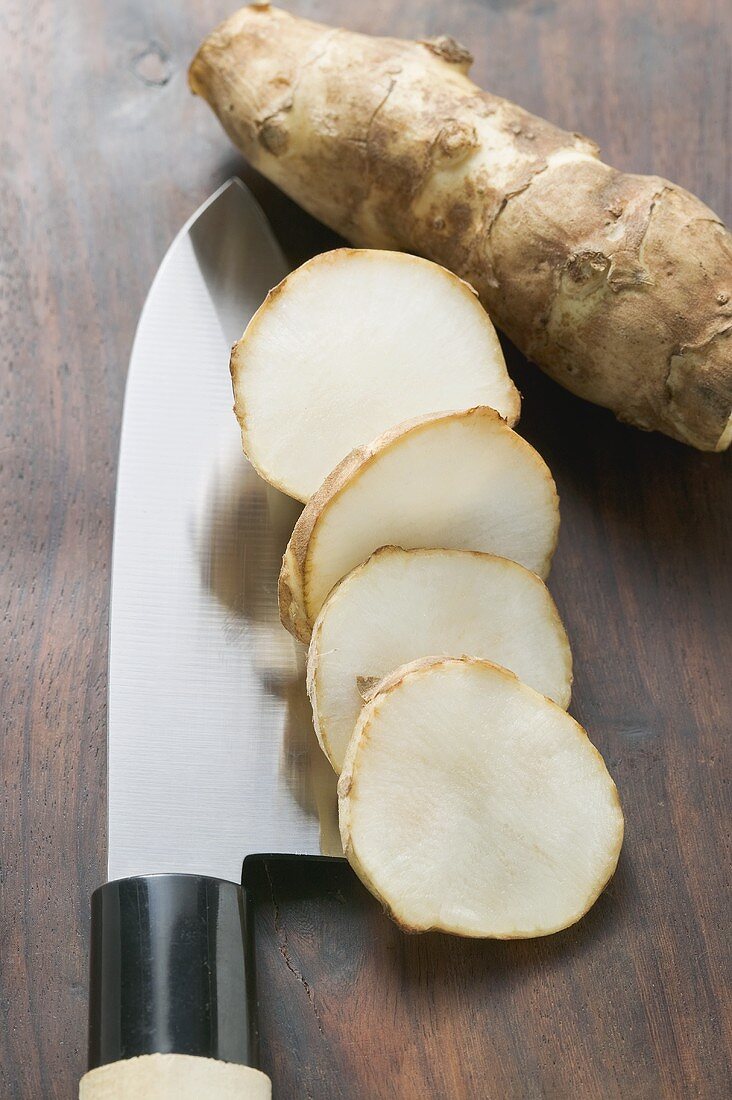 Fresh ginger root, whole and sliced