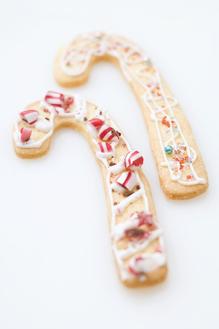 Two Christmas biscuits in the shape of candy canes