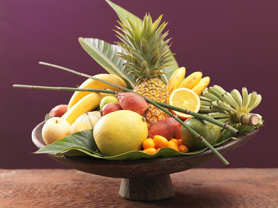 Still life: exotic fruit in wooden bowl