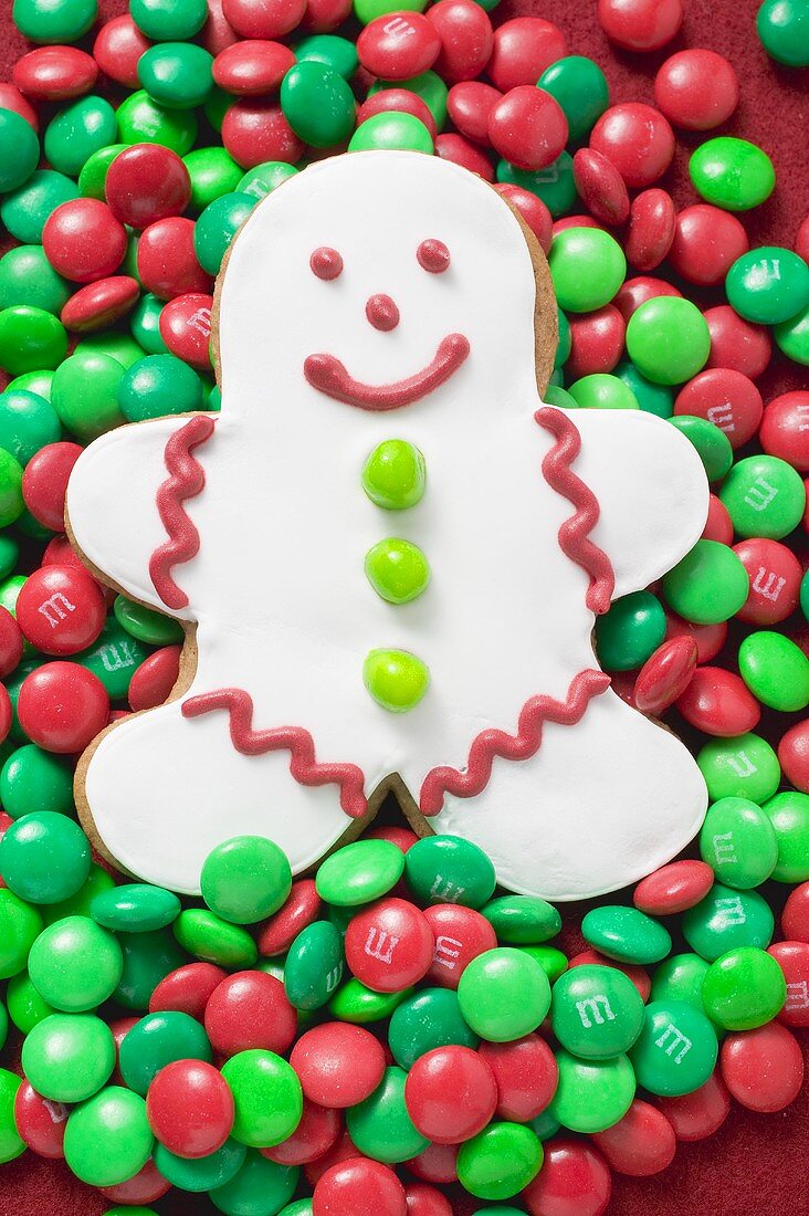White gingerbread man on red and green chocolate beans