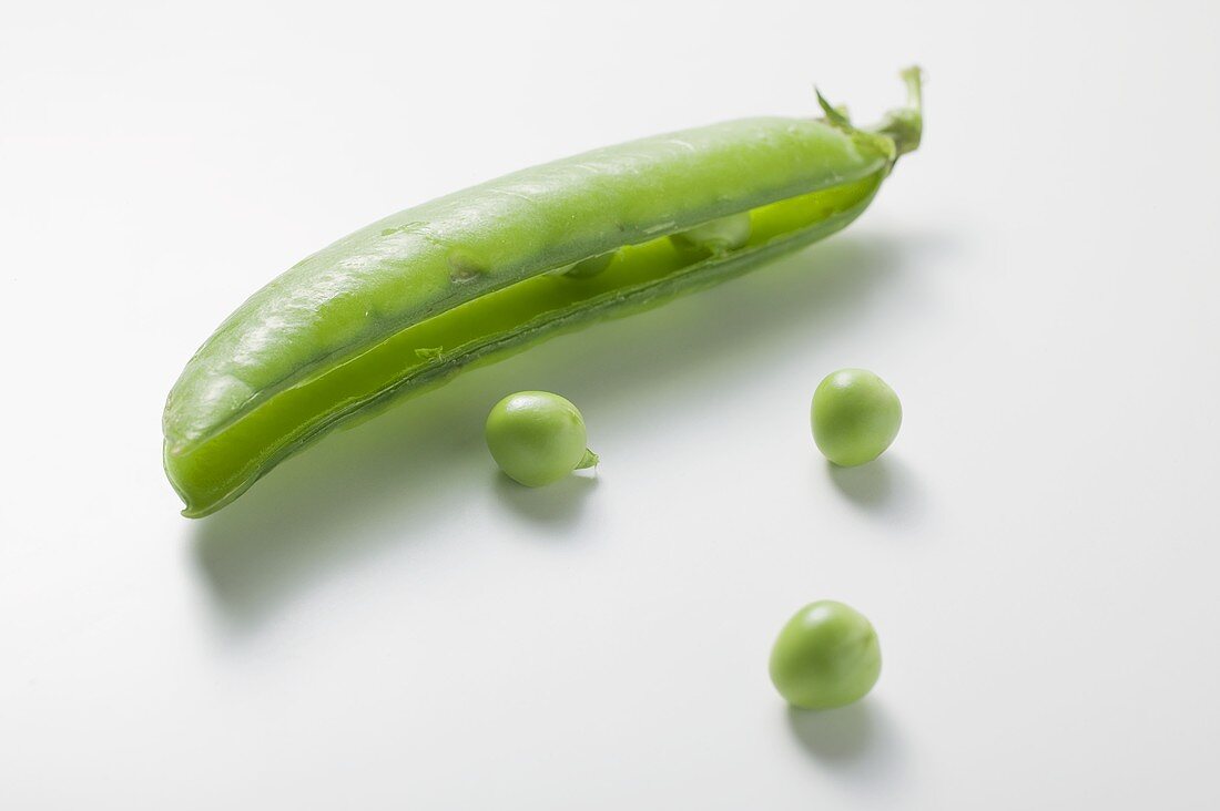 Pea pod, opened, and three peas