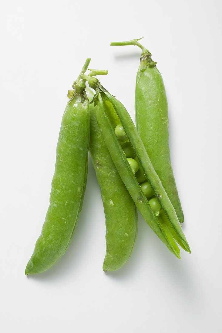 Four pea pods, one opened