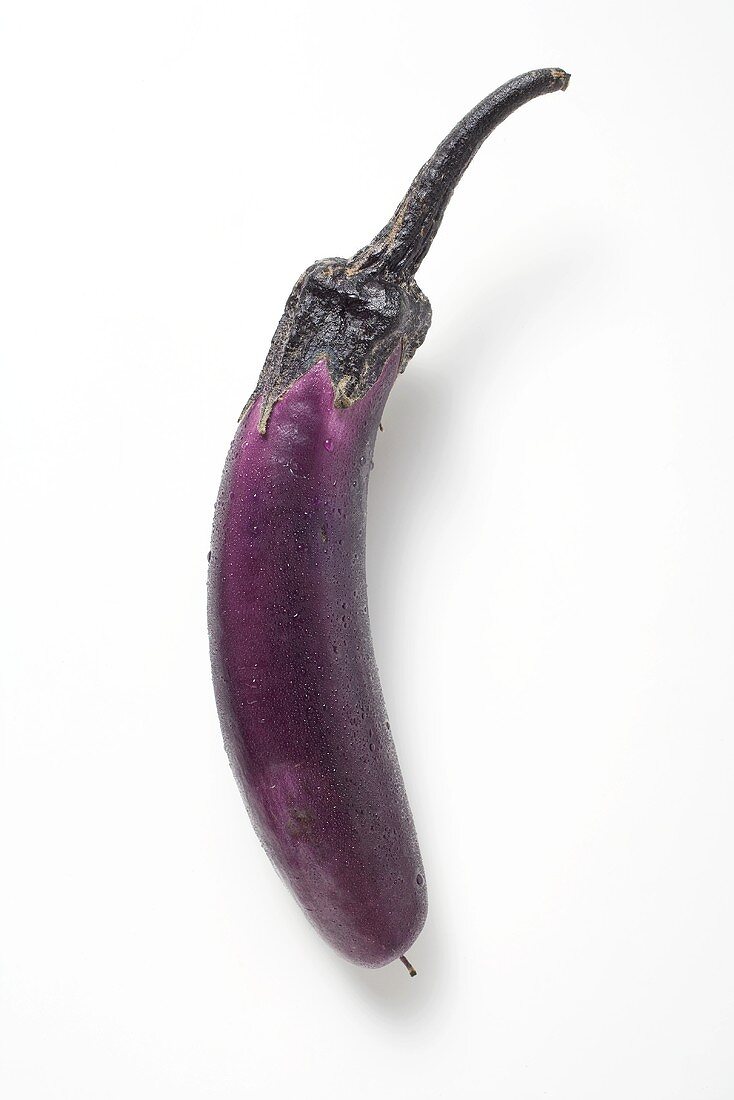 Thin purple aubergine with drops of water