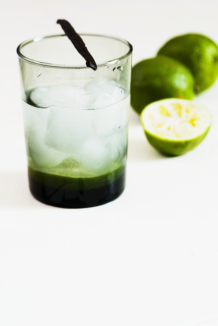 Mineral water with limes, ice cubes and vanilla pod