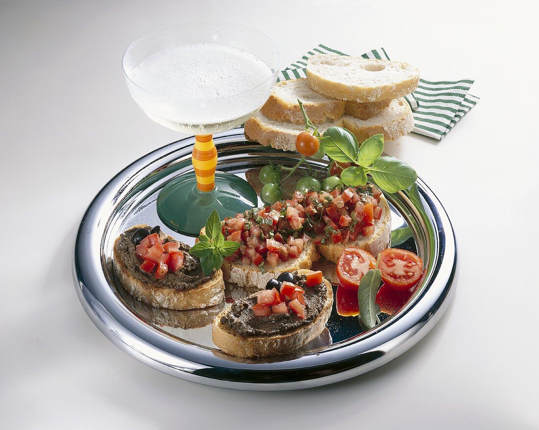 Crostini with tomatoes & olive paste & glass of sparkling wine