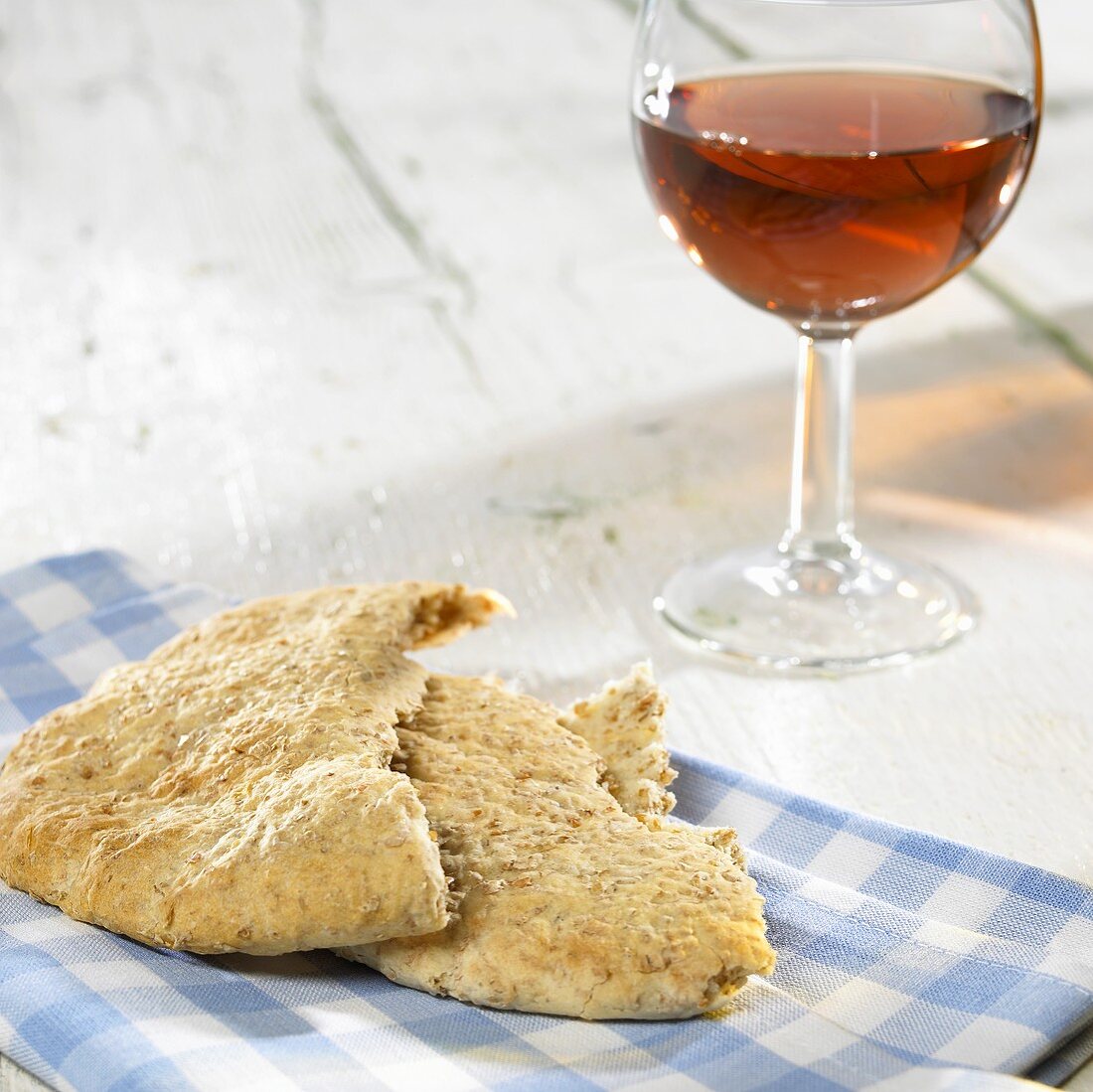 Pita bread and a glass of rosé wine