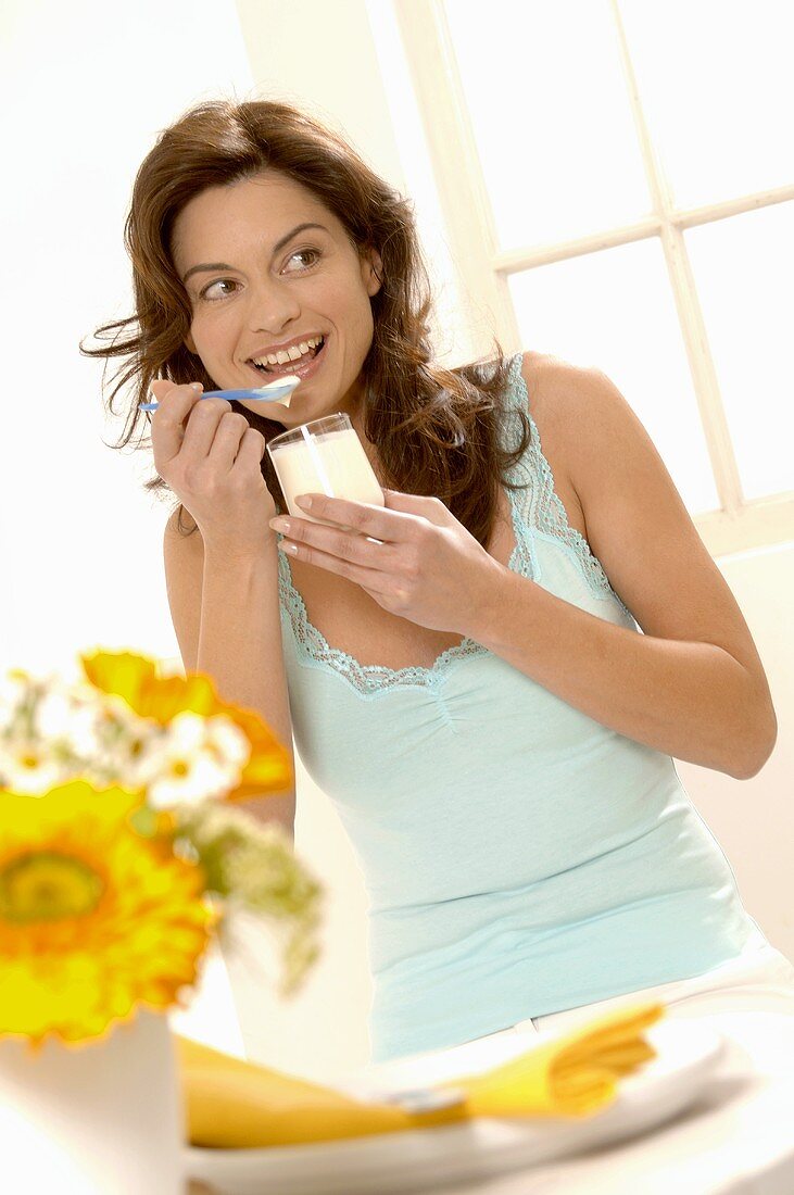 Woman eating natural yoghurt