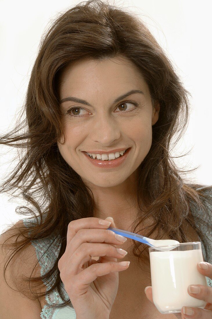 Woman eating natural yoghurt
