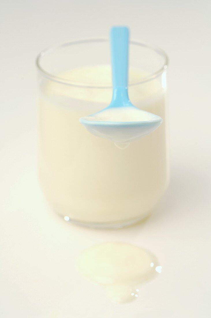 Yoghurt in glass and spoon