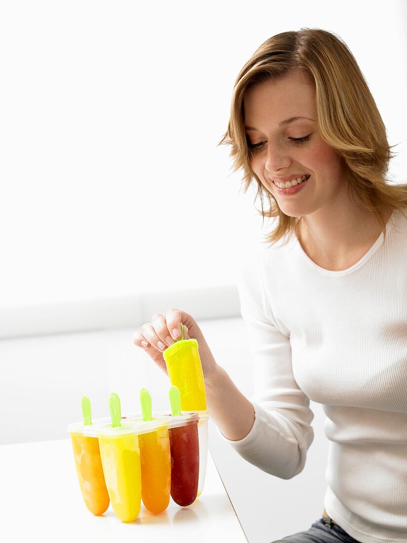 Woman with home-made fruit ice lollies