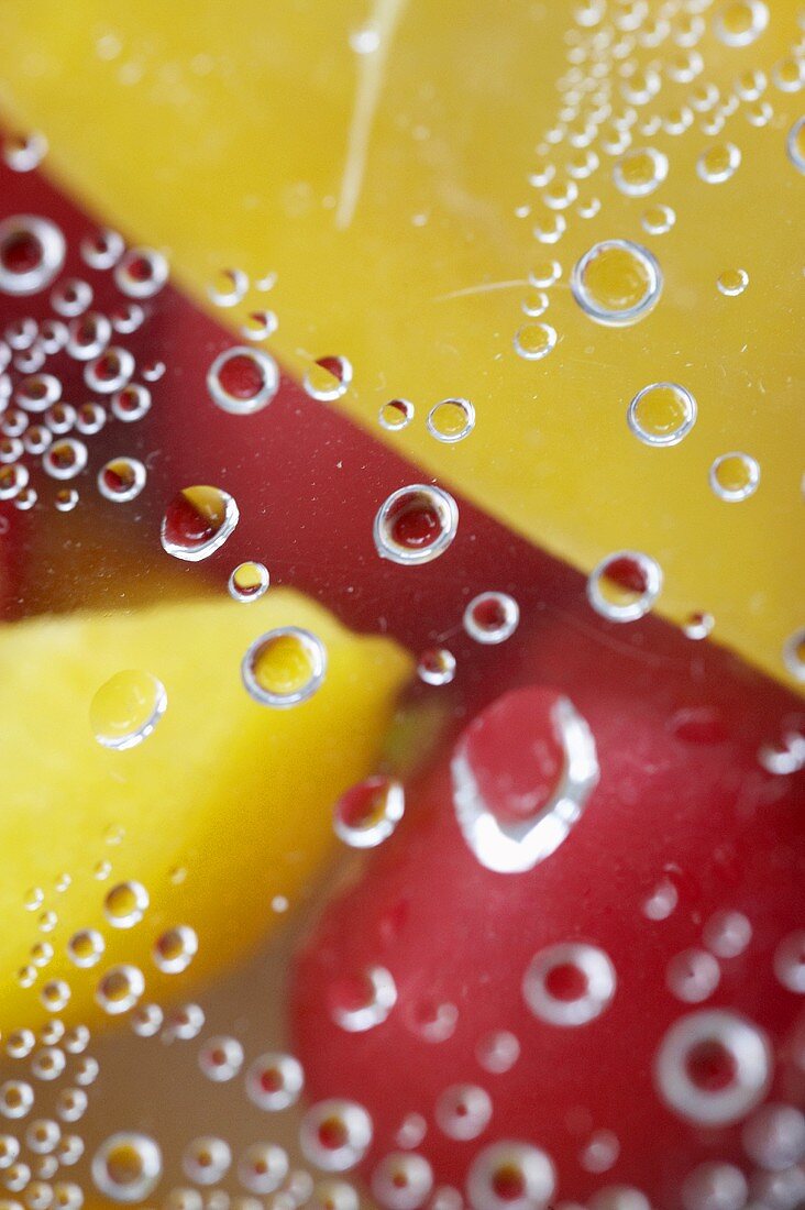 Peppers and radishes with drops of water (close-up)