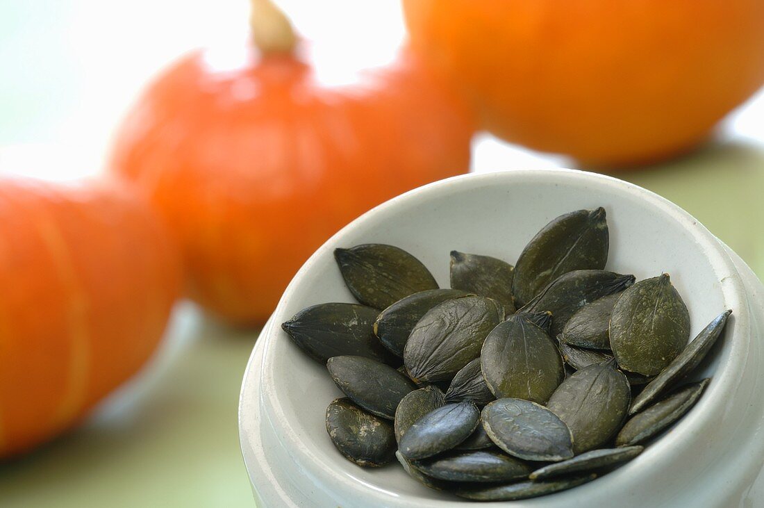 Pumpkin seeds, Hokkaido pumpkins in background