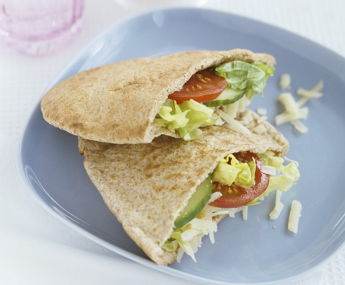 Wholemeal pita pockets filled with salad and grated cheese