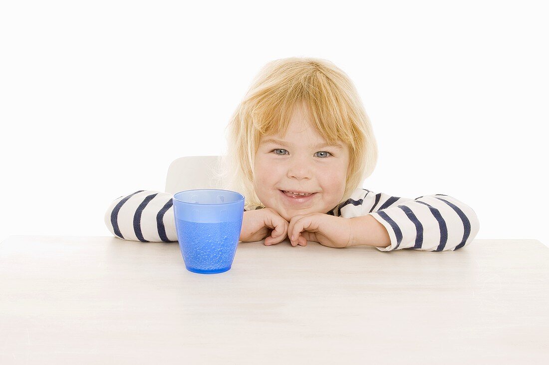 Little girl with beaker of water